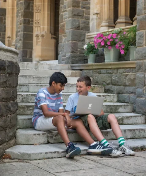 Two boys with computer laughing