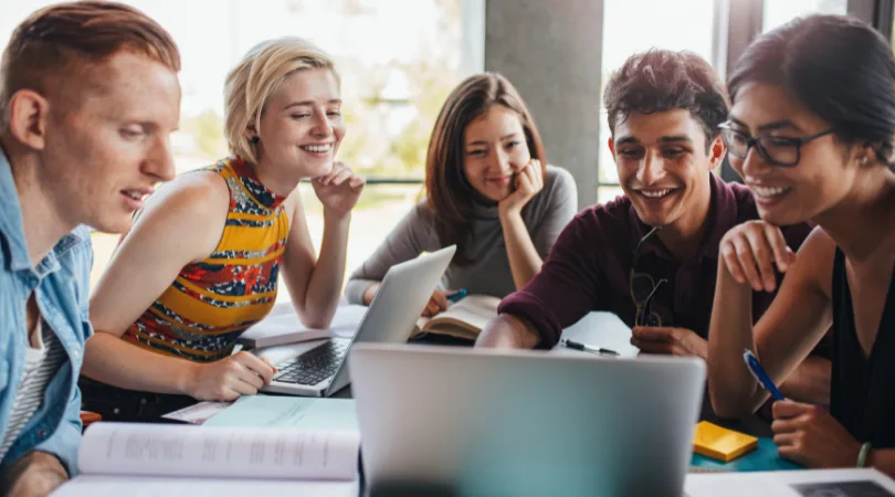 students-sat-around-an-open-laptop