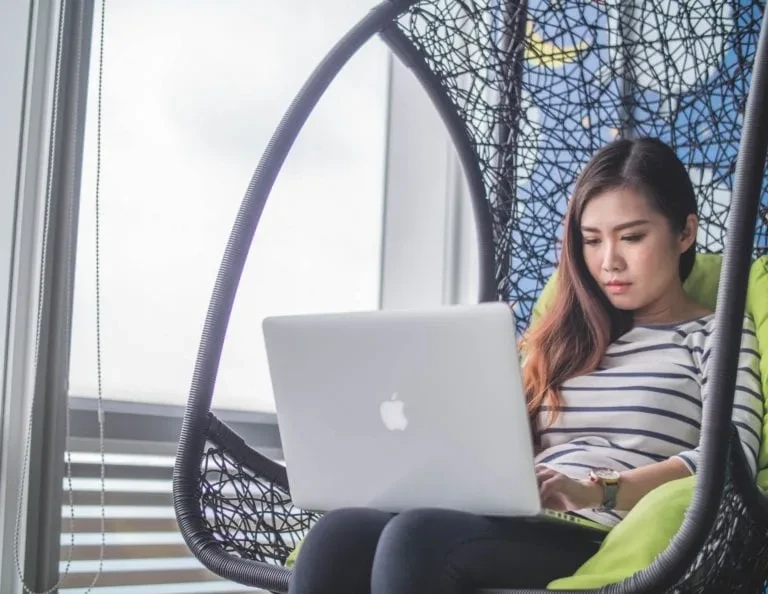 A girl sitting with a laptop