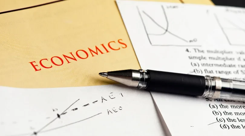 Economics book and pen