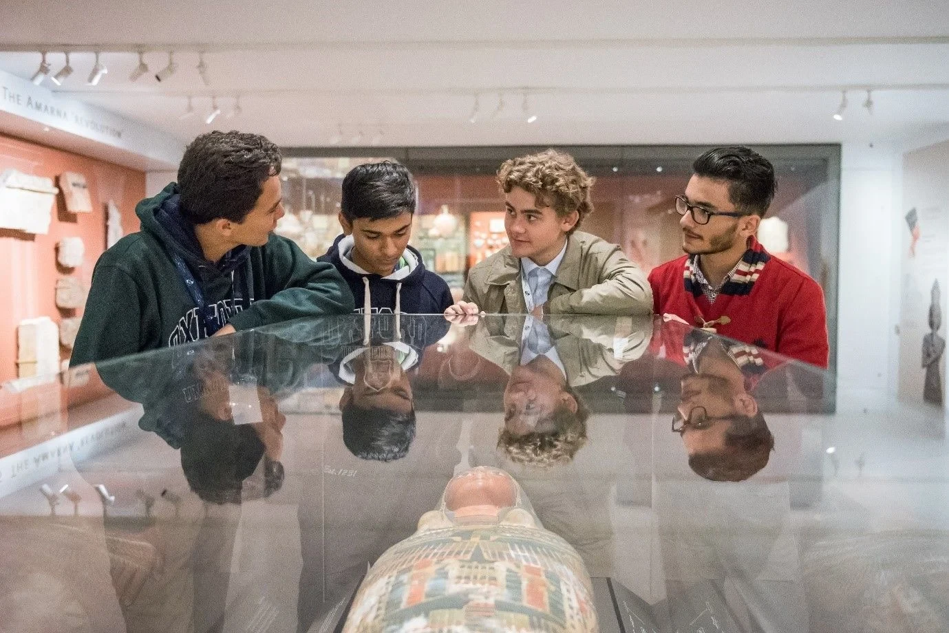 Four students looking at artifacts
