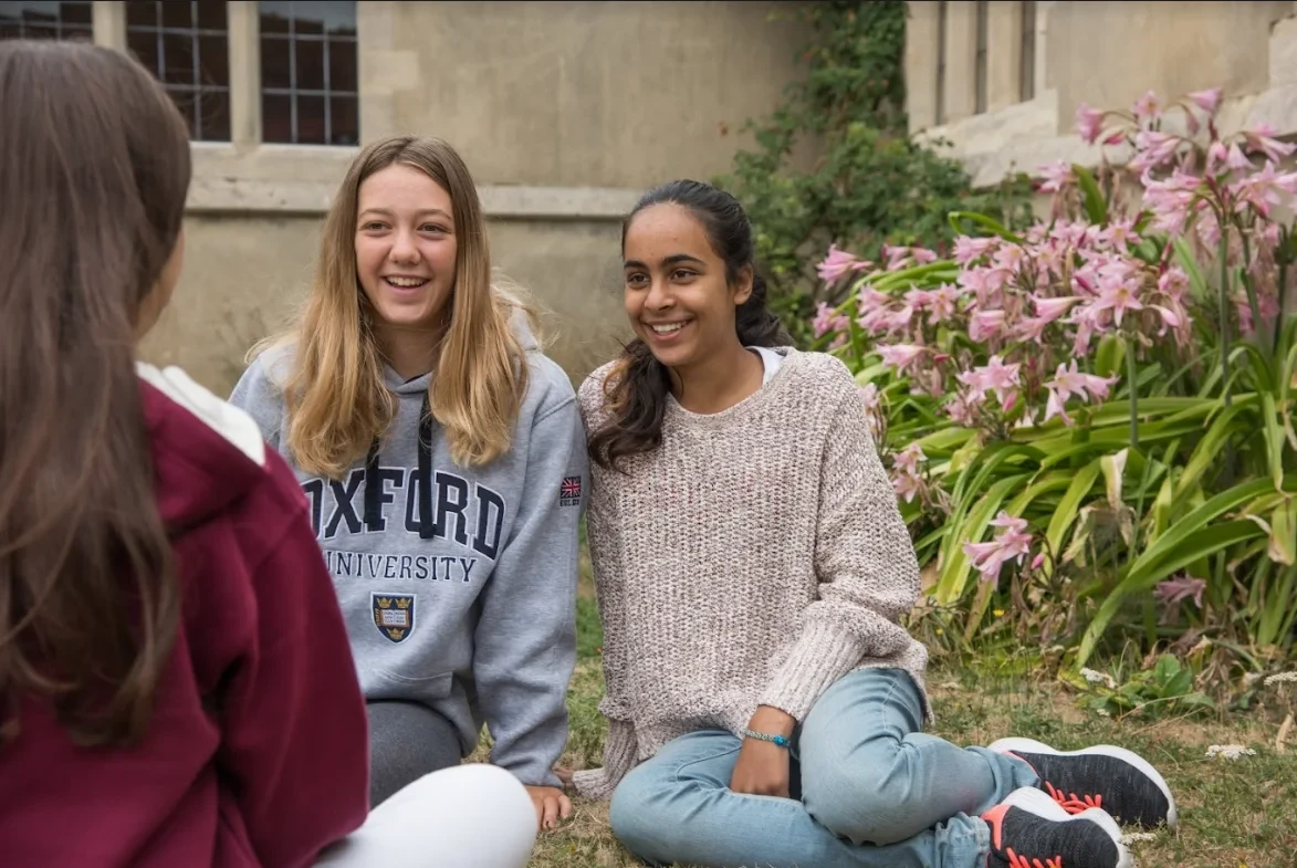 Students sitting on grass and talking