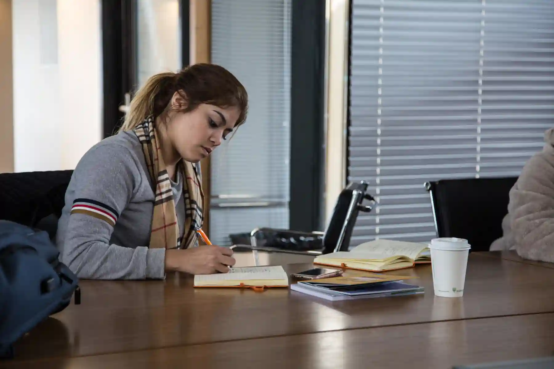 women writing in the notebook.