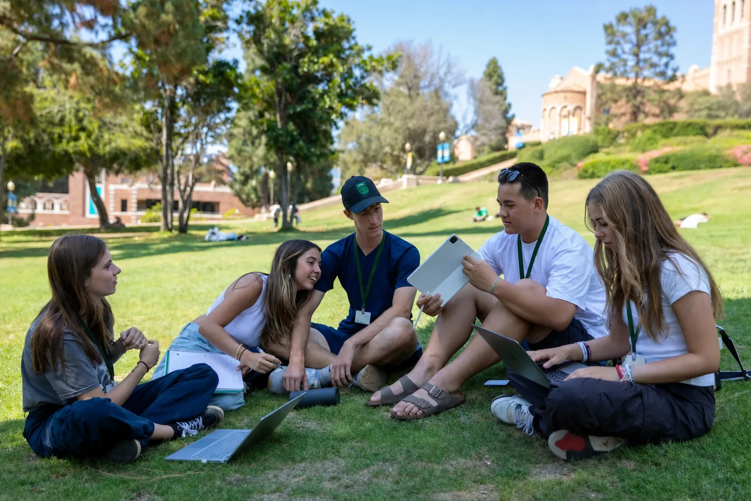 Students sitting on the lawn with their laptops on the UCLA campus in Los Angeles