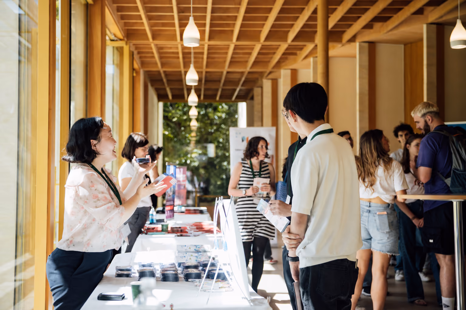 Students browsing stands and talking to representatives at a university fair