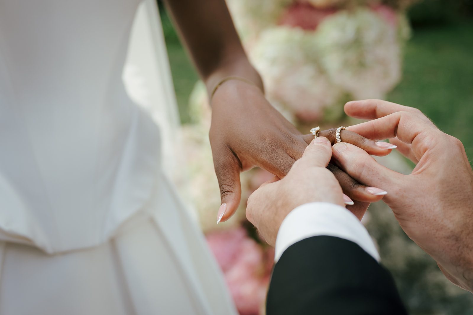 A couple exchanging rings at their wedding