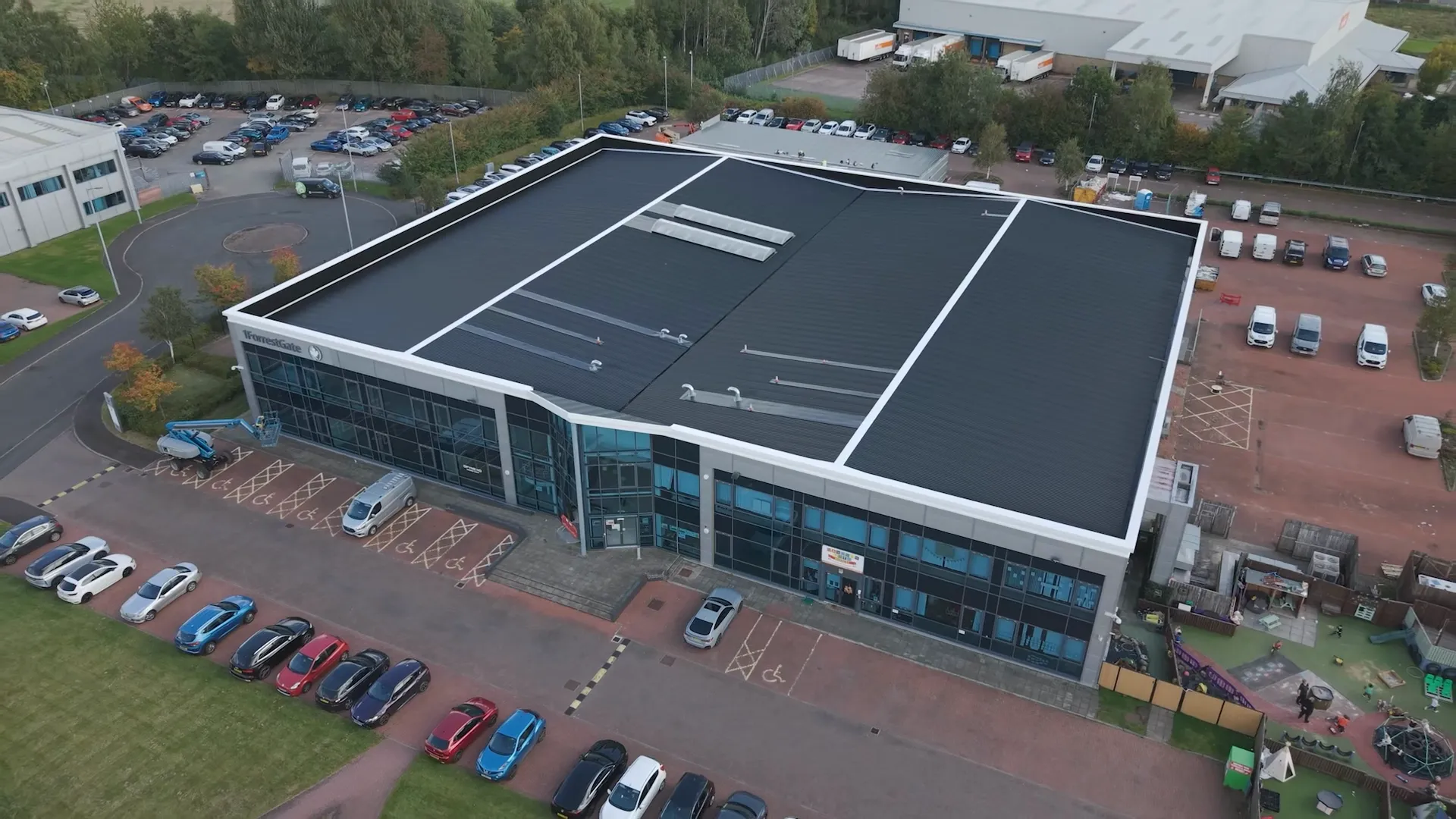 Aerial view of the finished dark metal roof and white perimeter flashings at the DFYNE project in Glasgow.