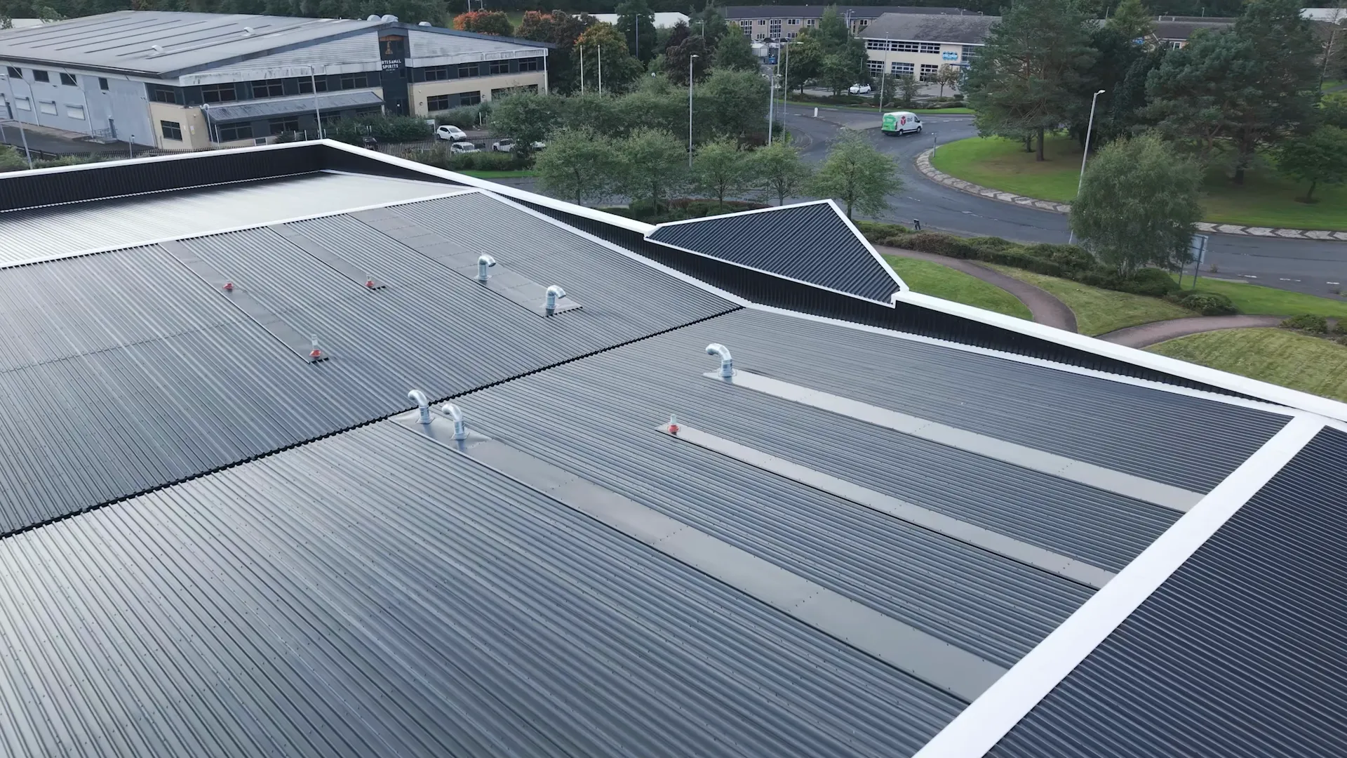 Profiled metal roof sheets, ventilation pipes and white edge flashings at the DFYNE project in Glasgow.