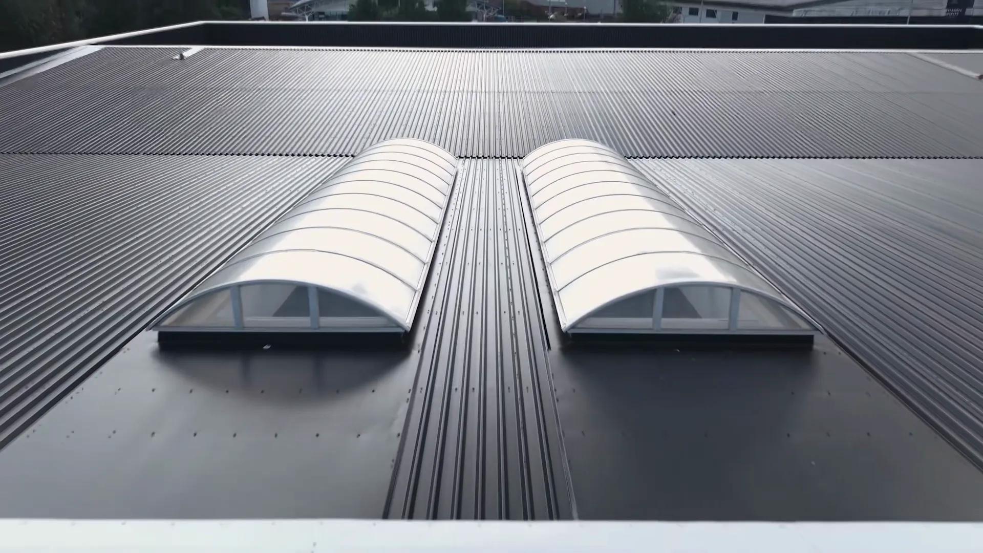 Two curved rooflights set into the profiled metal roof at the DFYNE project in Glasgow.