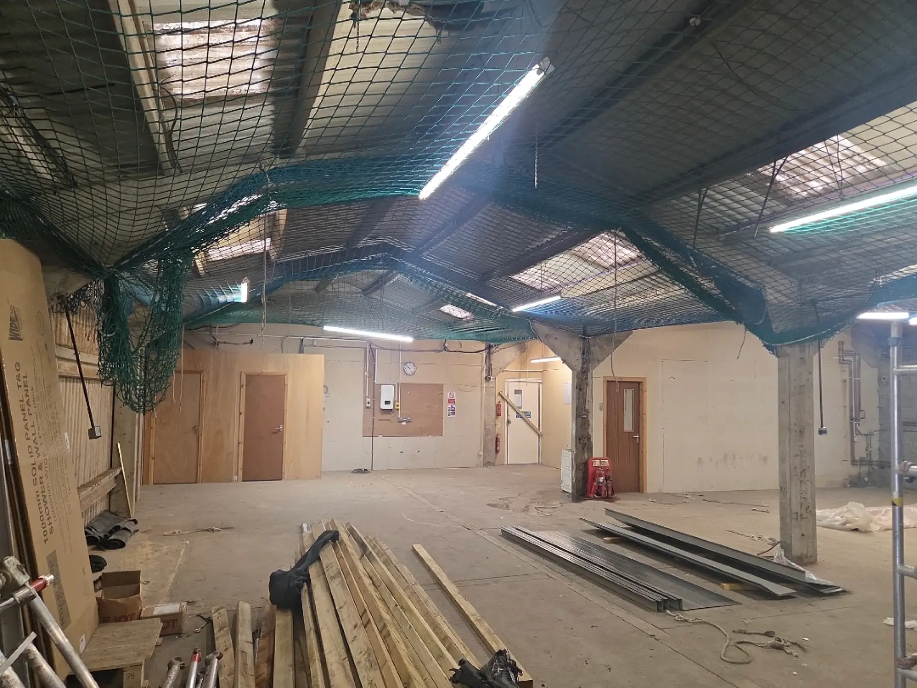 Inside the Gibson & Goold building in Ayr, with safety netting slung under the roof and timber and metal trims on the floor