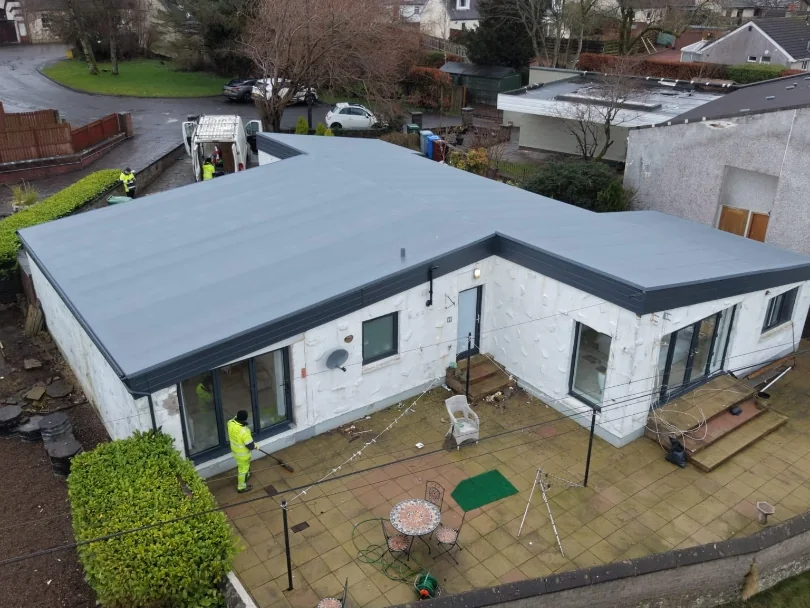 New grey flat roof on a single-storey house in Strathaven, viewed from above the garden.