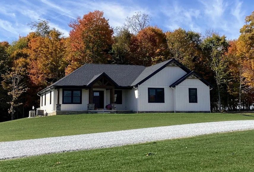 front of house with trees changing color