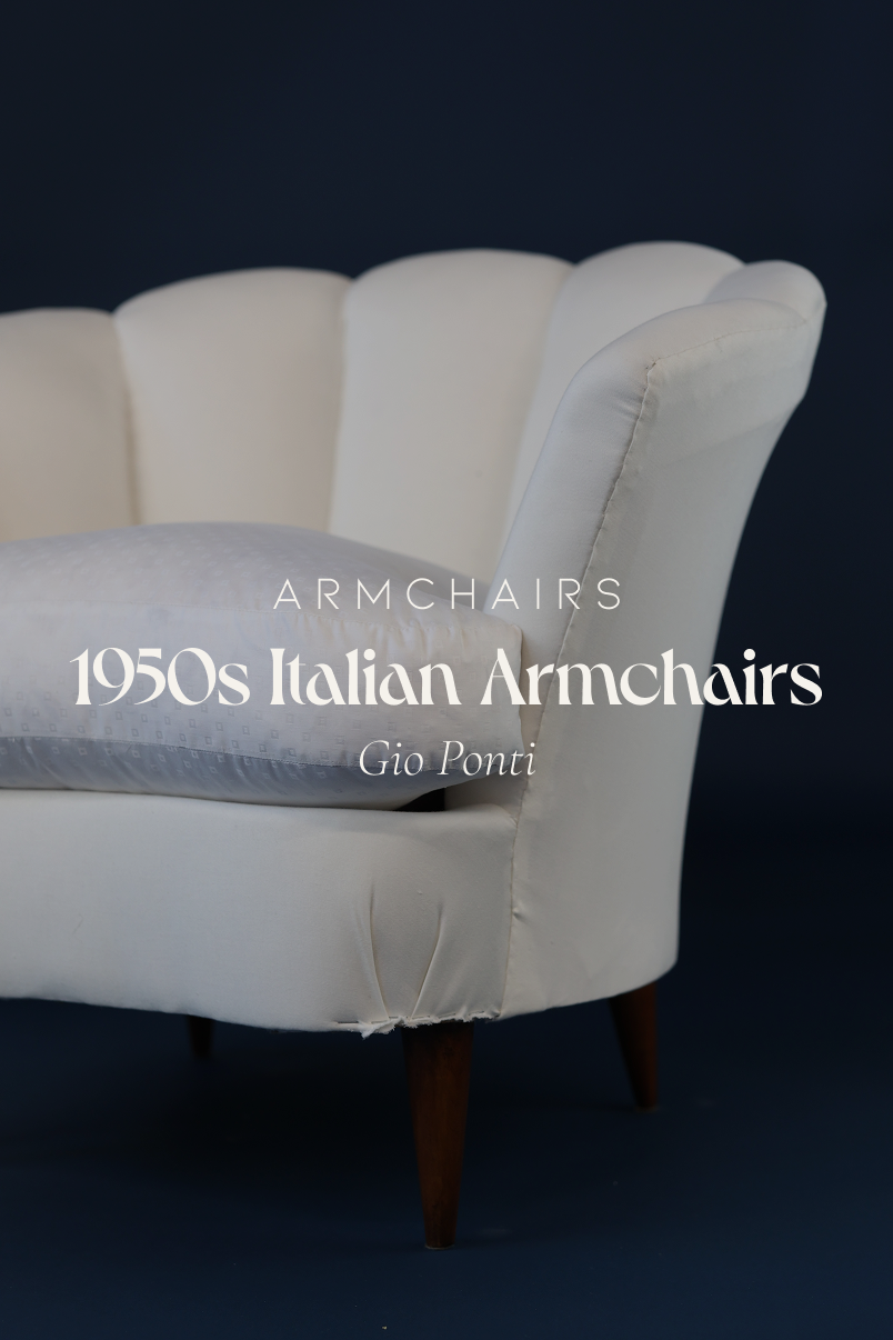 Pair of 1950s Italian armchairs by Gio Ponti - full front view with white upholstery on a blue background