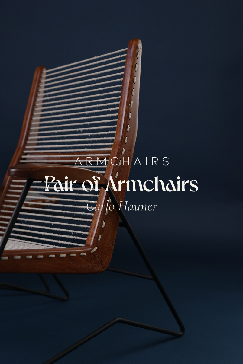 String armchair by Carlo Hauner - full front view with white cushions on a dark blue background