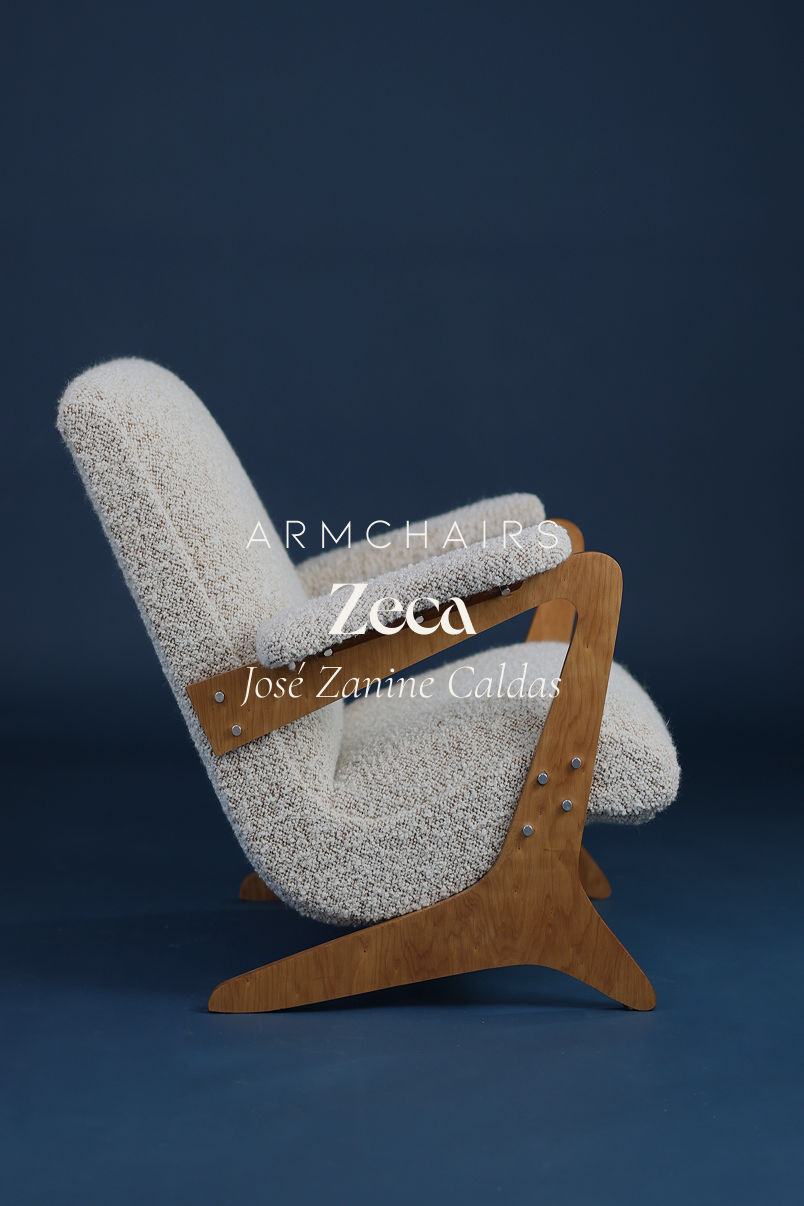 Zeca armchair by José Zanine Caldas - three-quarter front view featuring sculpted wooden armrests and white upholstery on a blue background