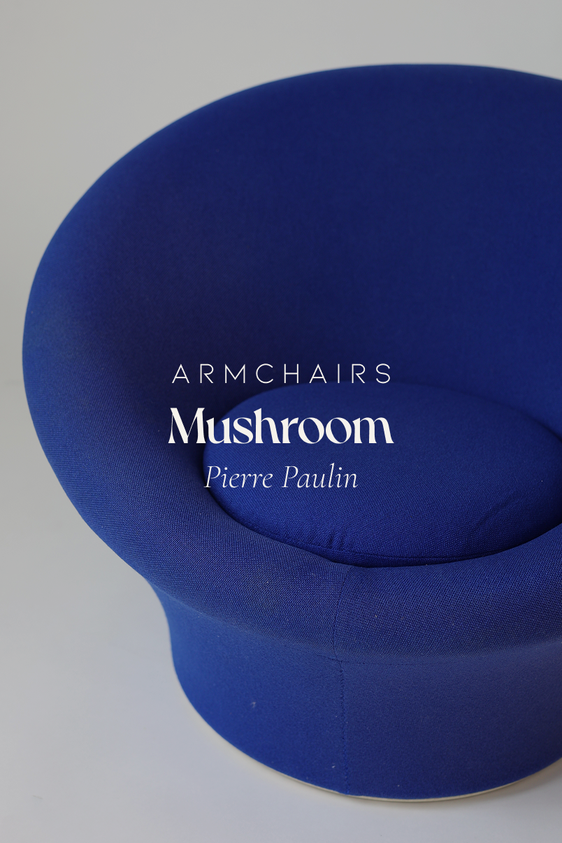 A three-quarter front view from above, showing the distinct round form of a dark blue upholstered Pierre Paulin Mushroom lounge chair.