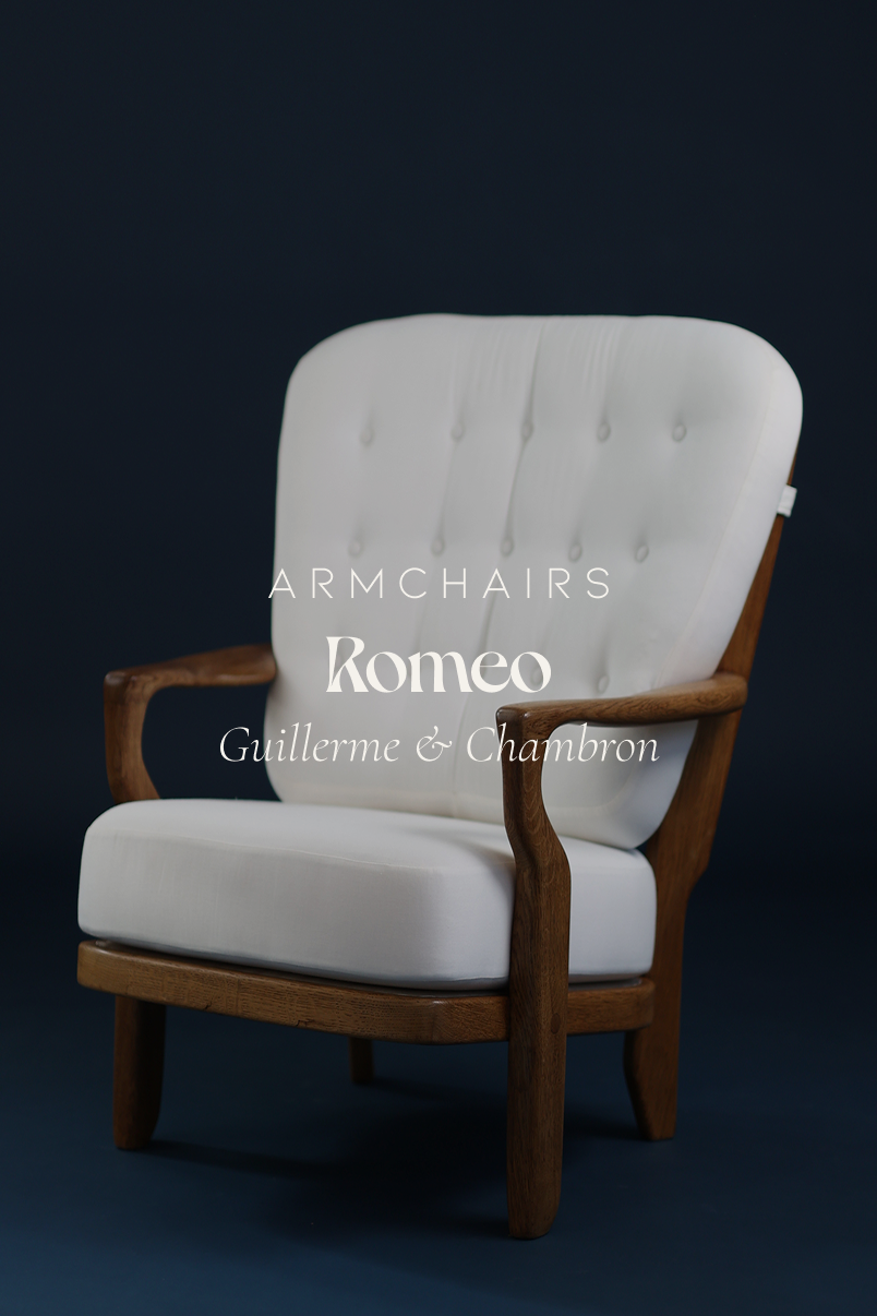 Romeo armchair by Guillerme et Chambron - full front view with white upholstery and solid oak frame on a dark blue background