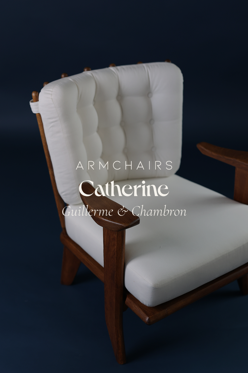 Catherine armchair by Guillerme et Chambron - full front view featuring white button-tufted upholstery and solid oak frame on a dark blue background