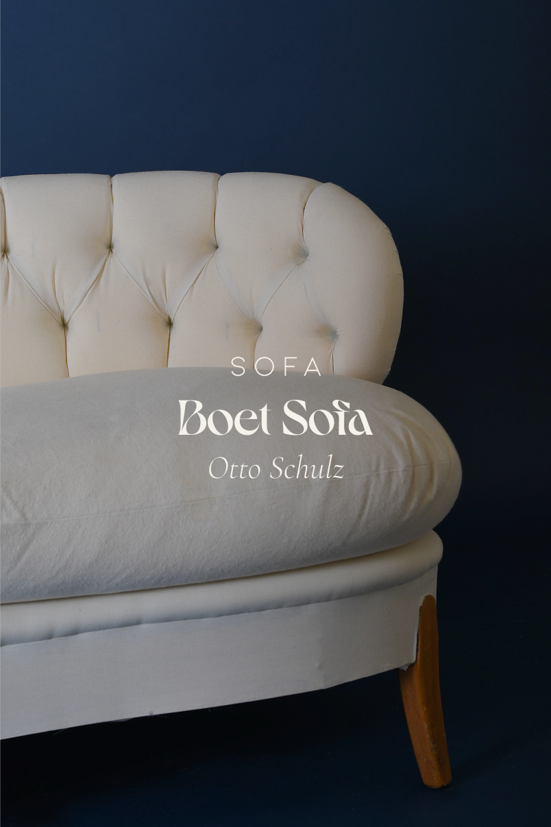 A full front view of the cream-colored, upholstered Boet sofa by Otto Schulz, featuring tapered wooden legs and a distinctive tufted backrest.
