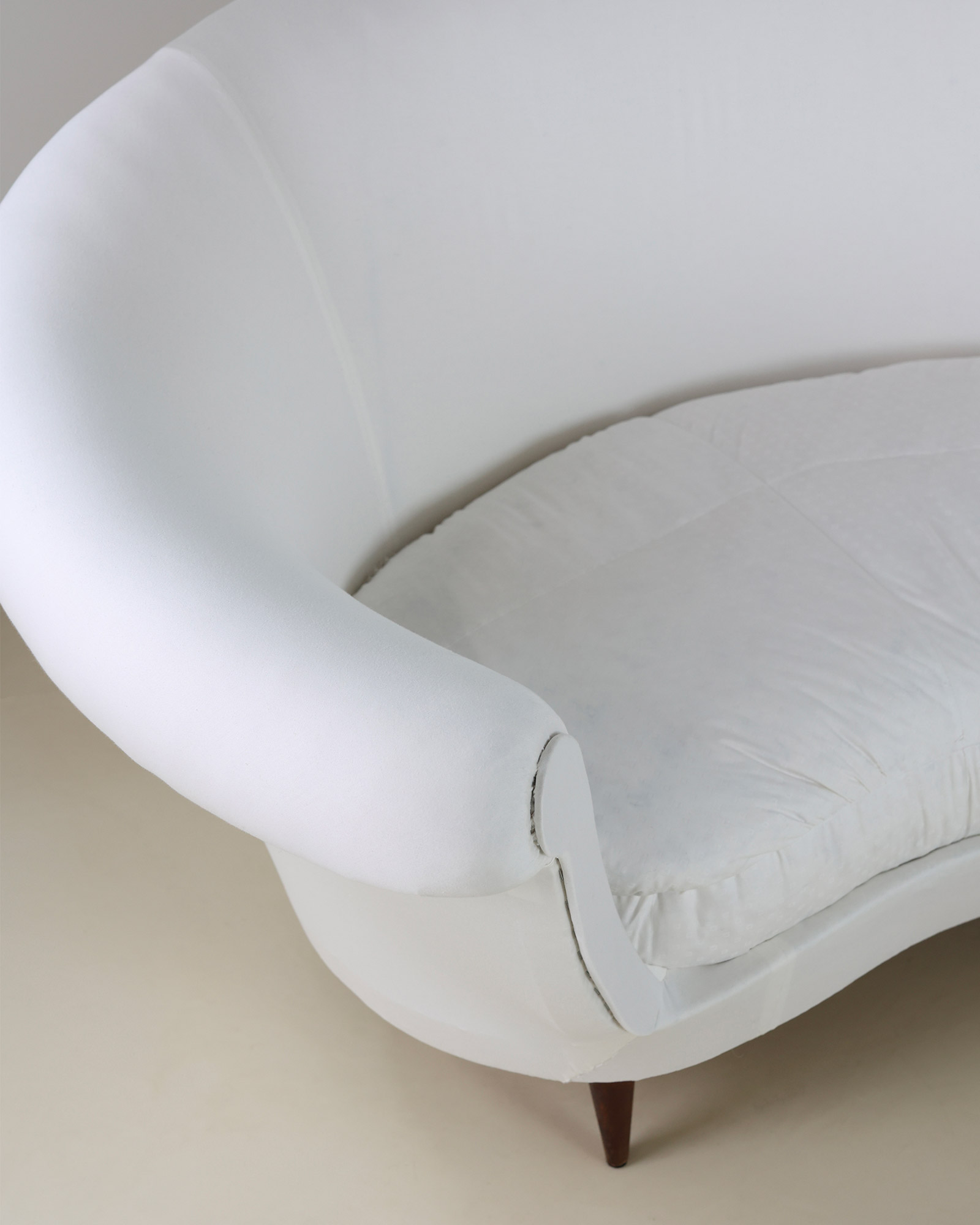 Munari curved sofa by Federico Munari - angled perspective highlighting the rounded armrest and backrest design