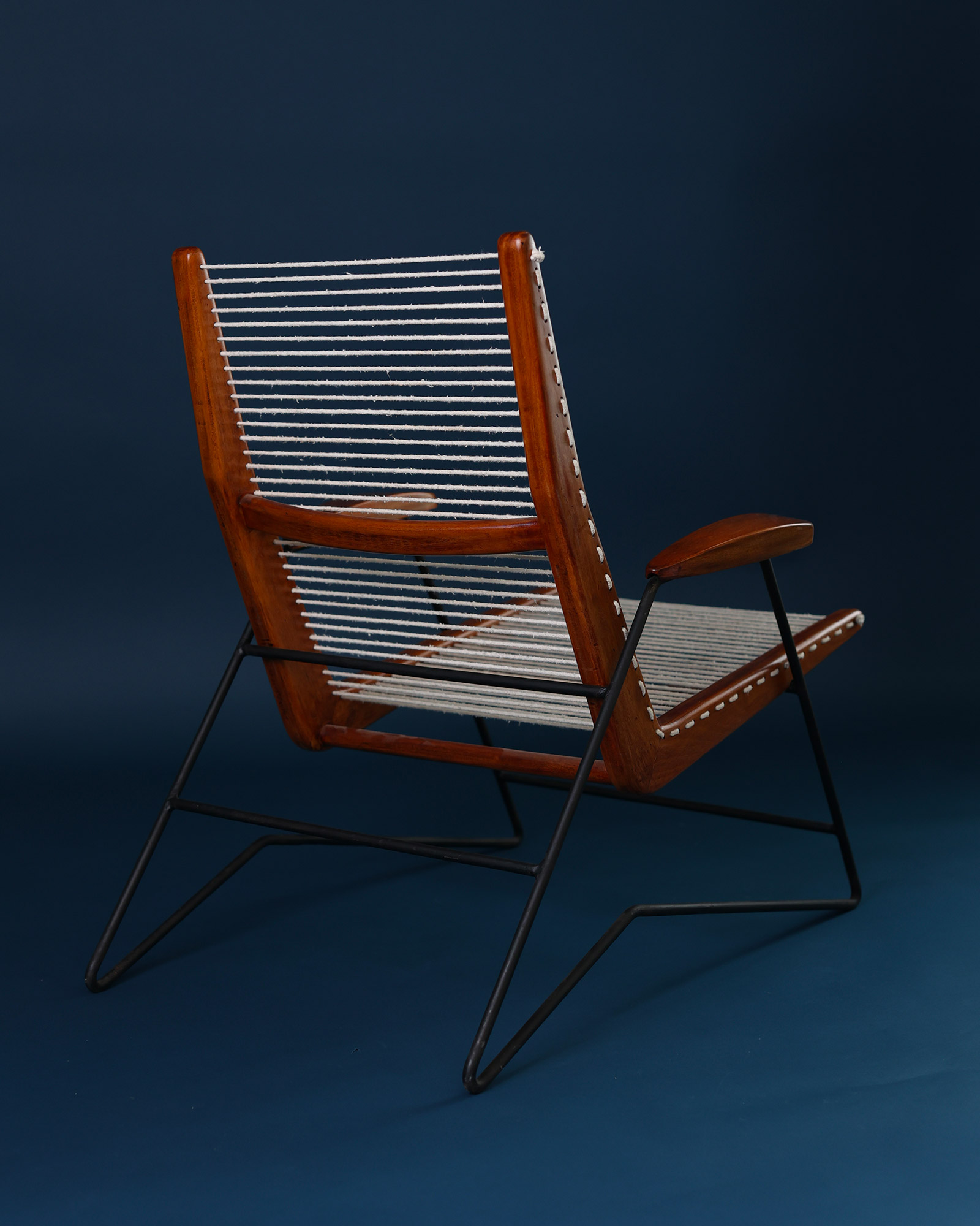 String armchair by Carlo Hauner - rear three-quarter view showing the backrest structure and frame design