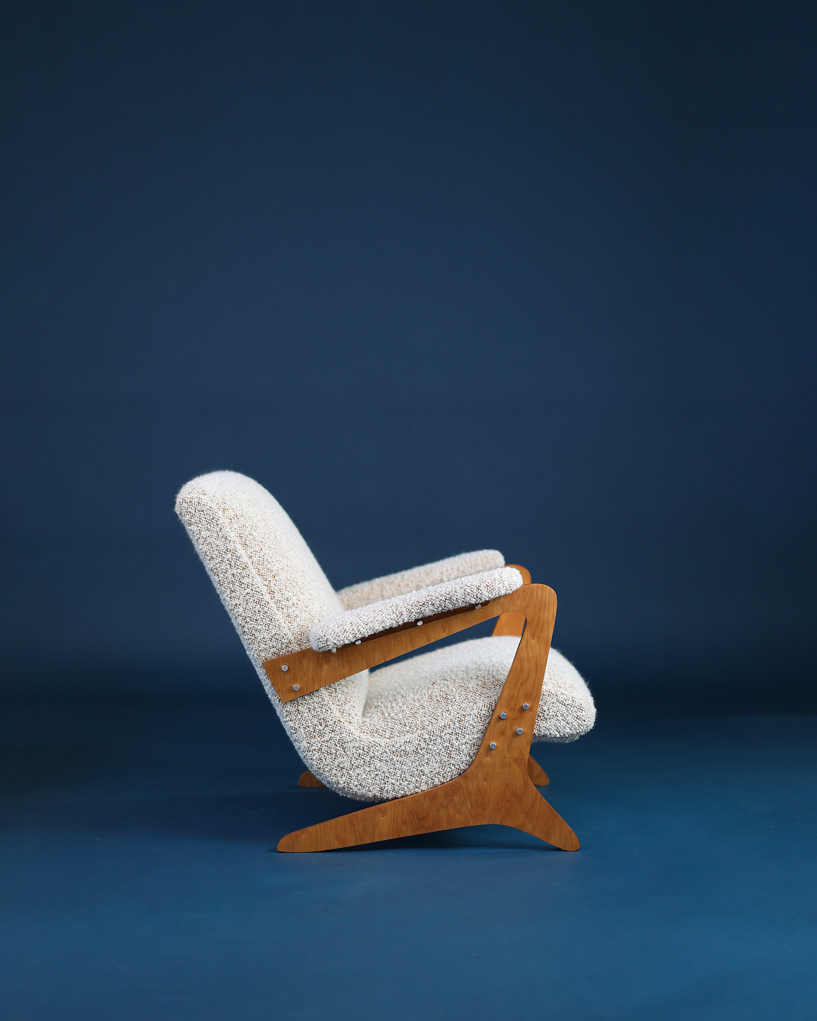 Zeca armchair by José Zanine Caldas - side angle highlighting the organic wooden frame structure and seat profile