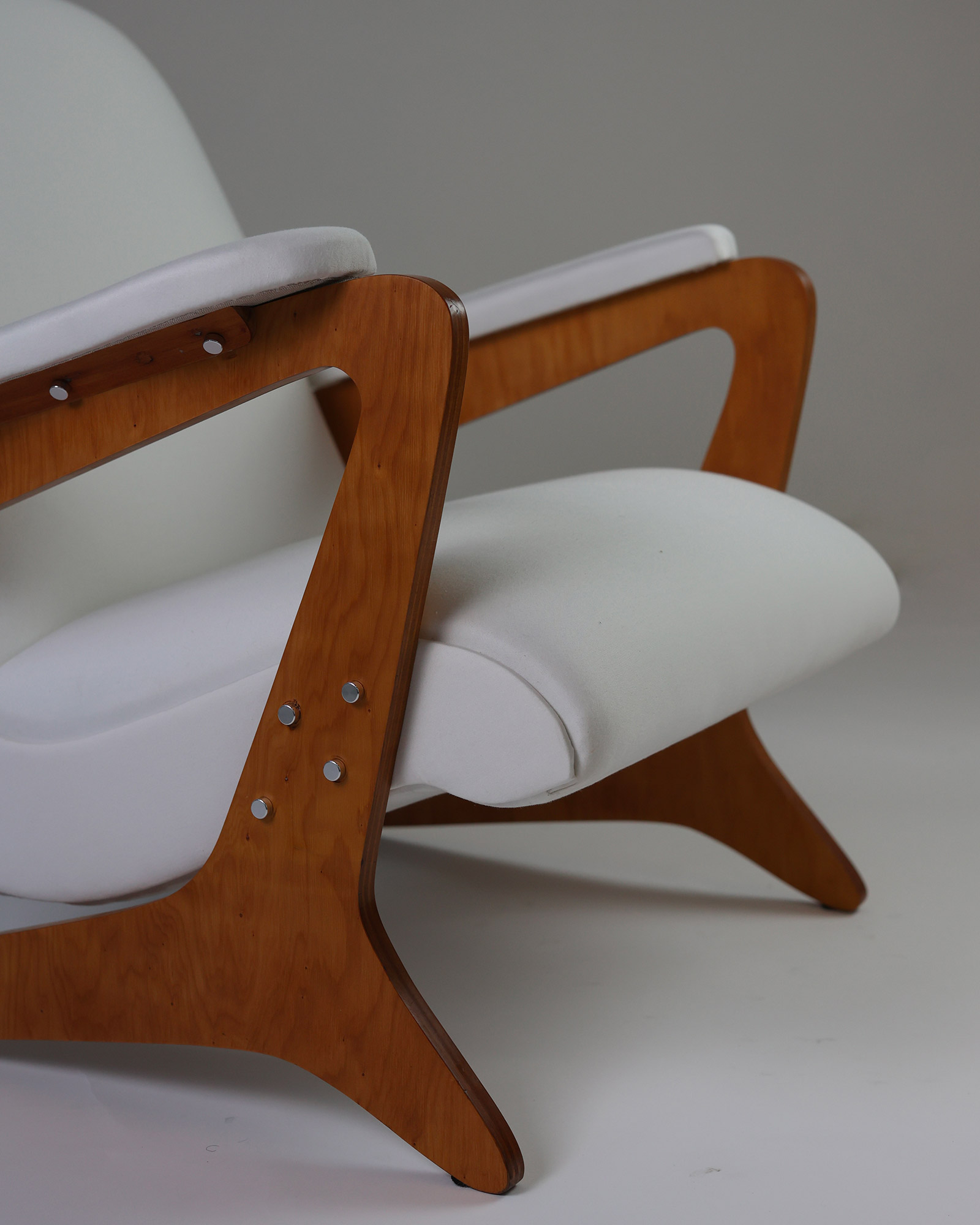 Zeca armchair by José Zanine Caldas - close-up detail of the hand-carved wooden armrest and fabric upholstery