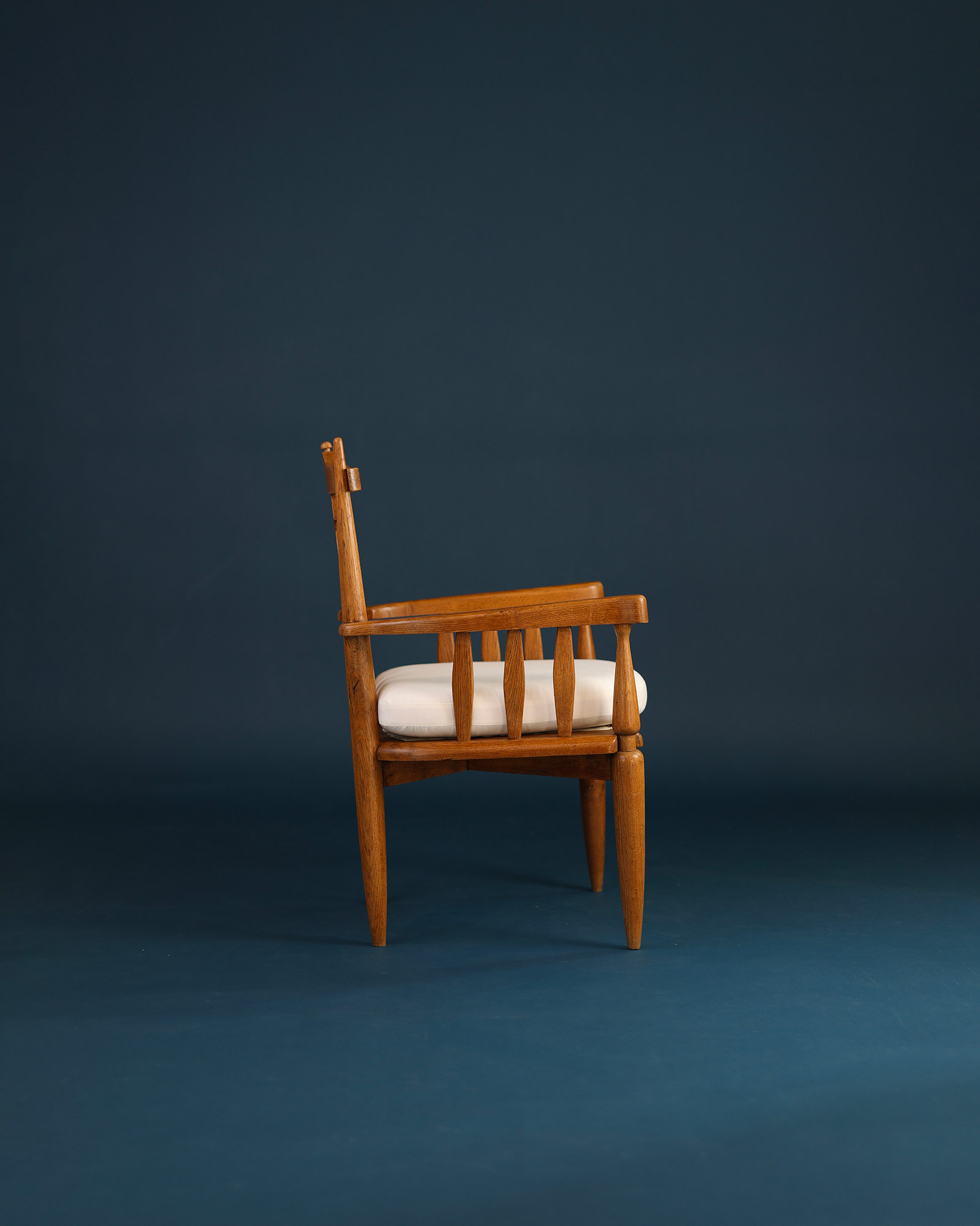 Unknown 1950s wooden armchair - side profile angle highlighting the armrest and wooden frame structure