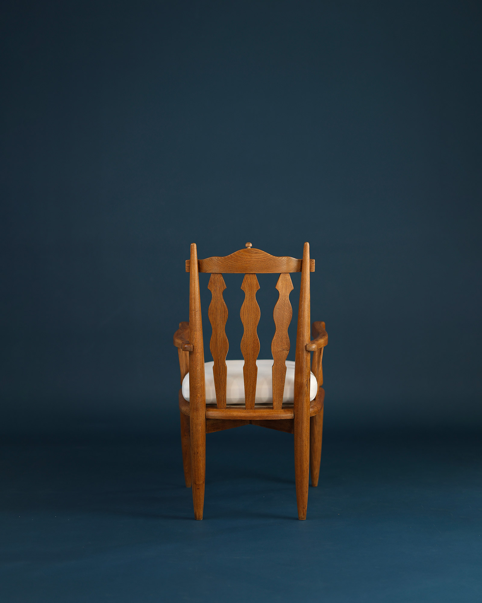 Unknown 1950s wooden armchair - full front view showing the backrest design and striped cushion
