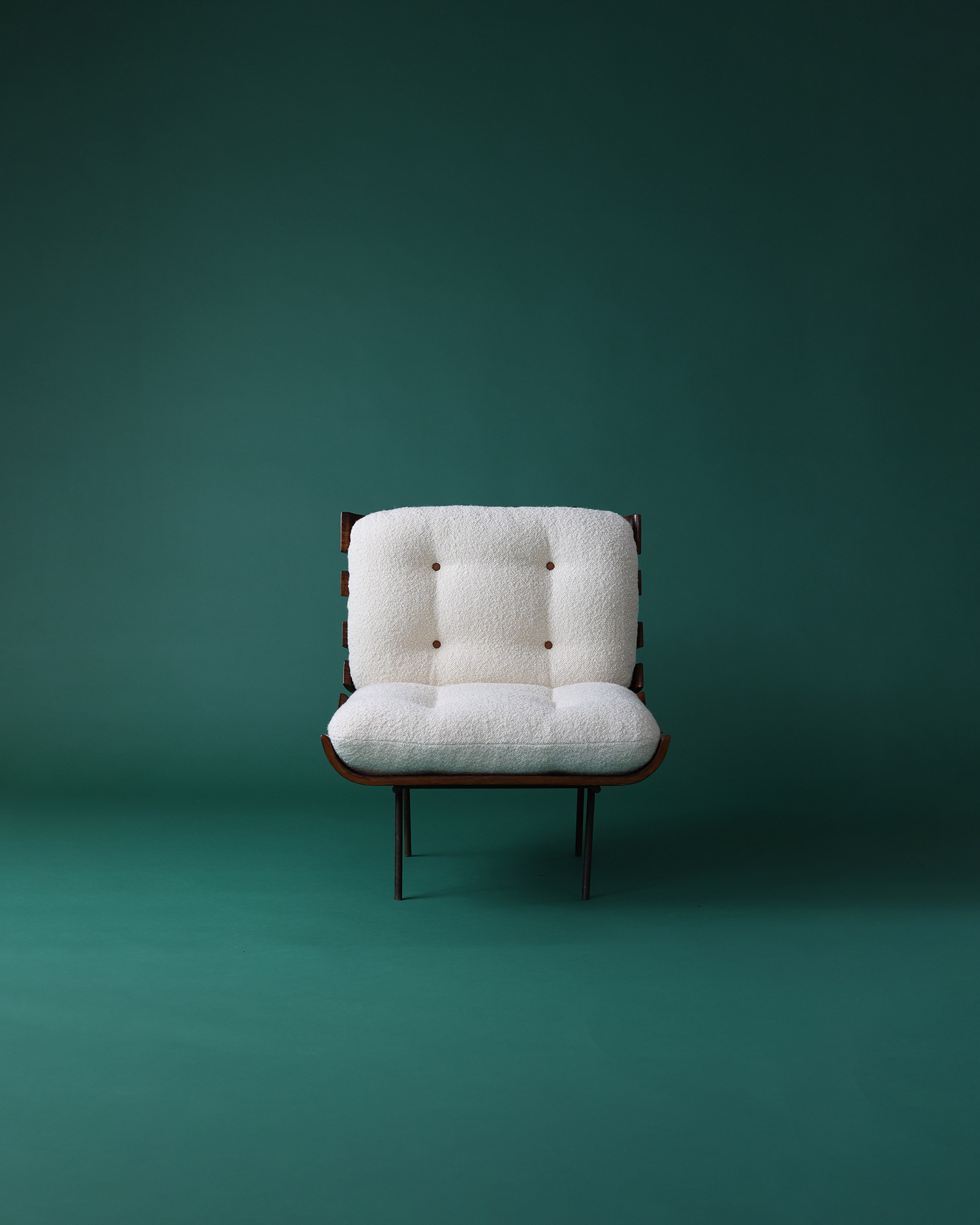 Costela armchair by Martin Eisler and Carlo Hauner - full front view with white tufted cushion and wooden slat frame on a green background