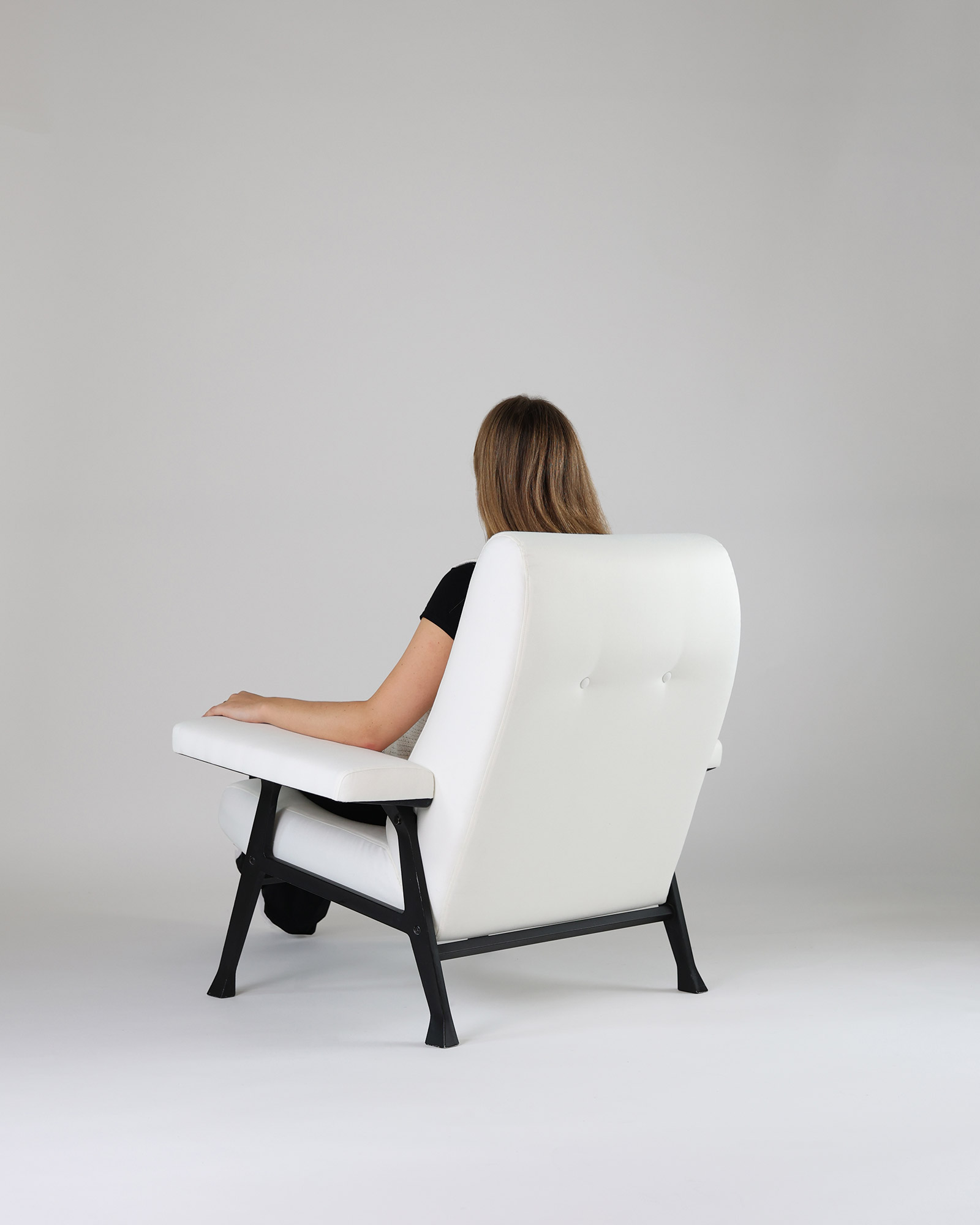 Hall armchair by Roberto Menghi - rear three-quarter angle showcasing the backrest shell structure and base