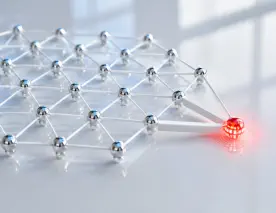 Card: When one cybersecurity breach becomes everyone’s problem represented by a geometric lattice network. The nodes are small, polished silver spheres connected by thin white rods, floating above a reflective light gray surface. One node on the outer edge glows with a localized, dense red light grid. The surrounding connecting rods instantly turn a solid, thick matte-white, visually decoupling the compromised node and keeping the rest of the vast, silver lattice completely pristine and unaffected.