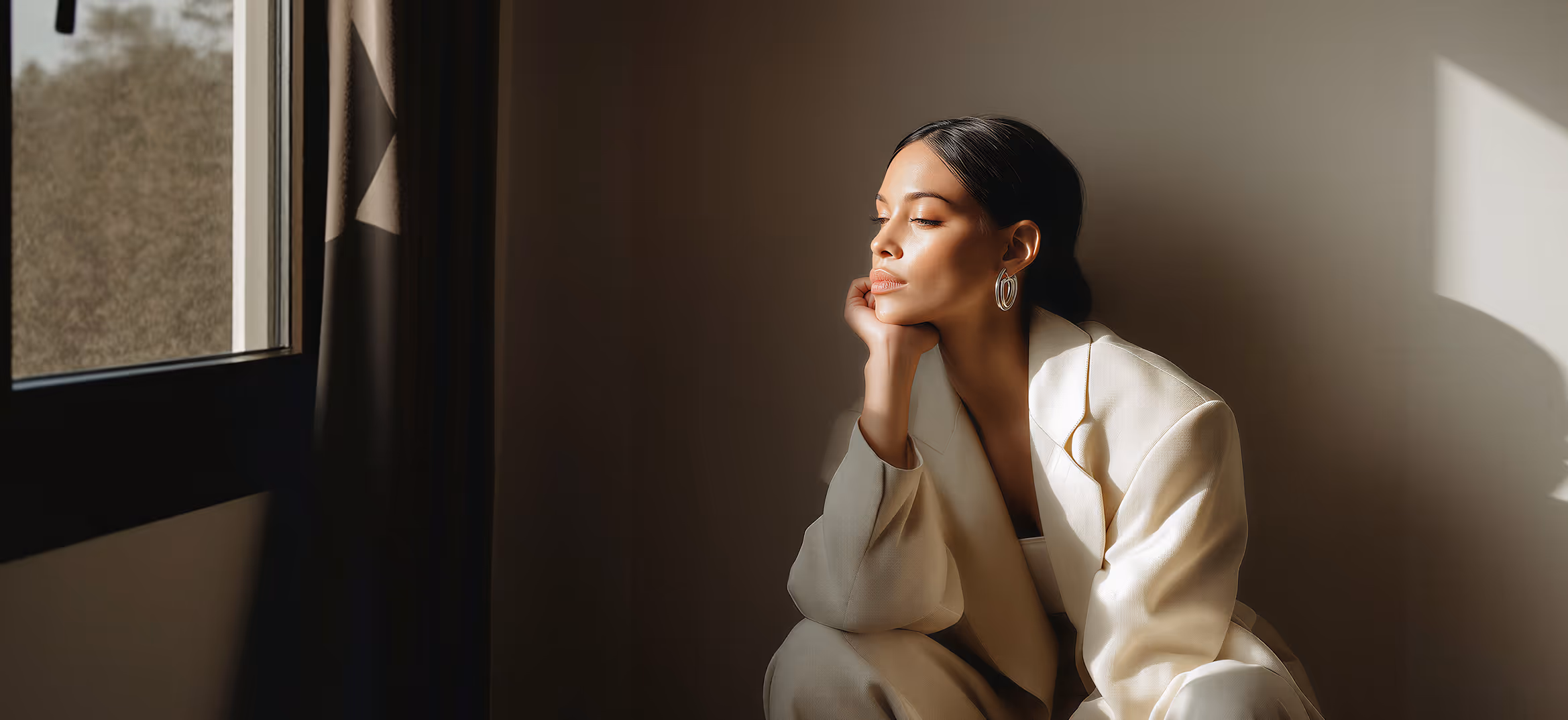 Therapy website hero image showing a woman in soft light, representing support for burnout, anxiety, and emotional wellness.