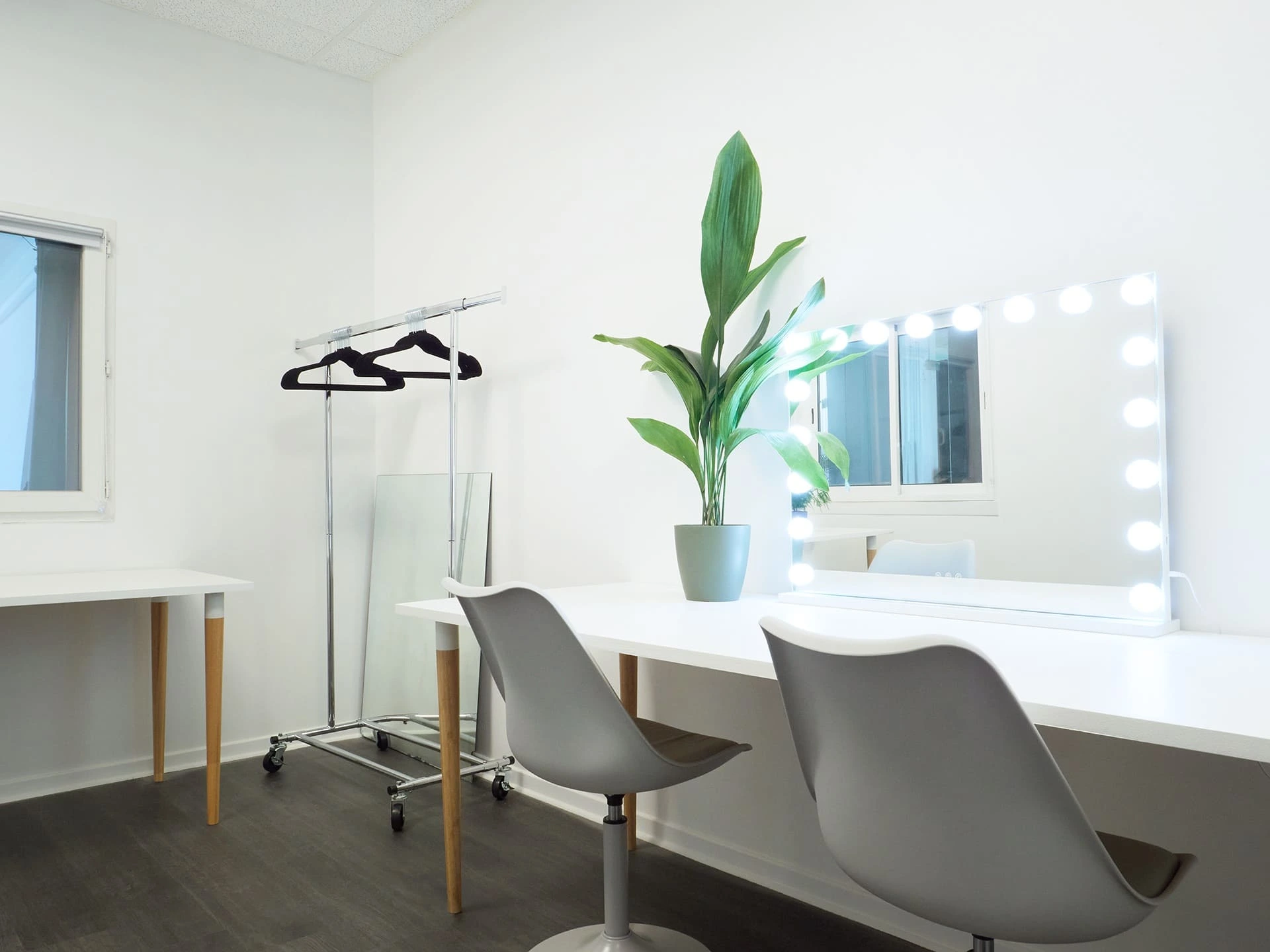 Dressing room with lit mirror and clothing rack at Spline's Set B filming studio