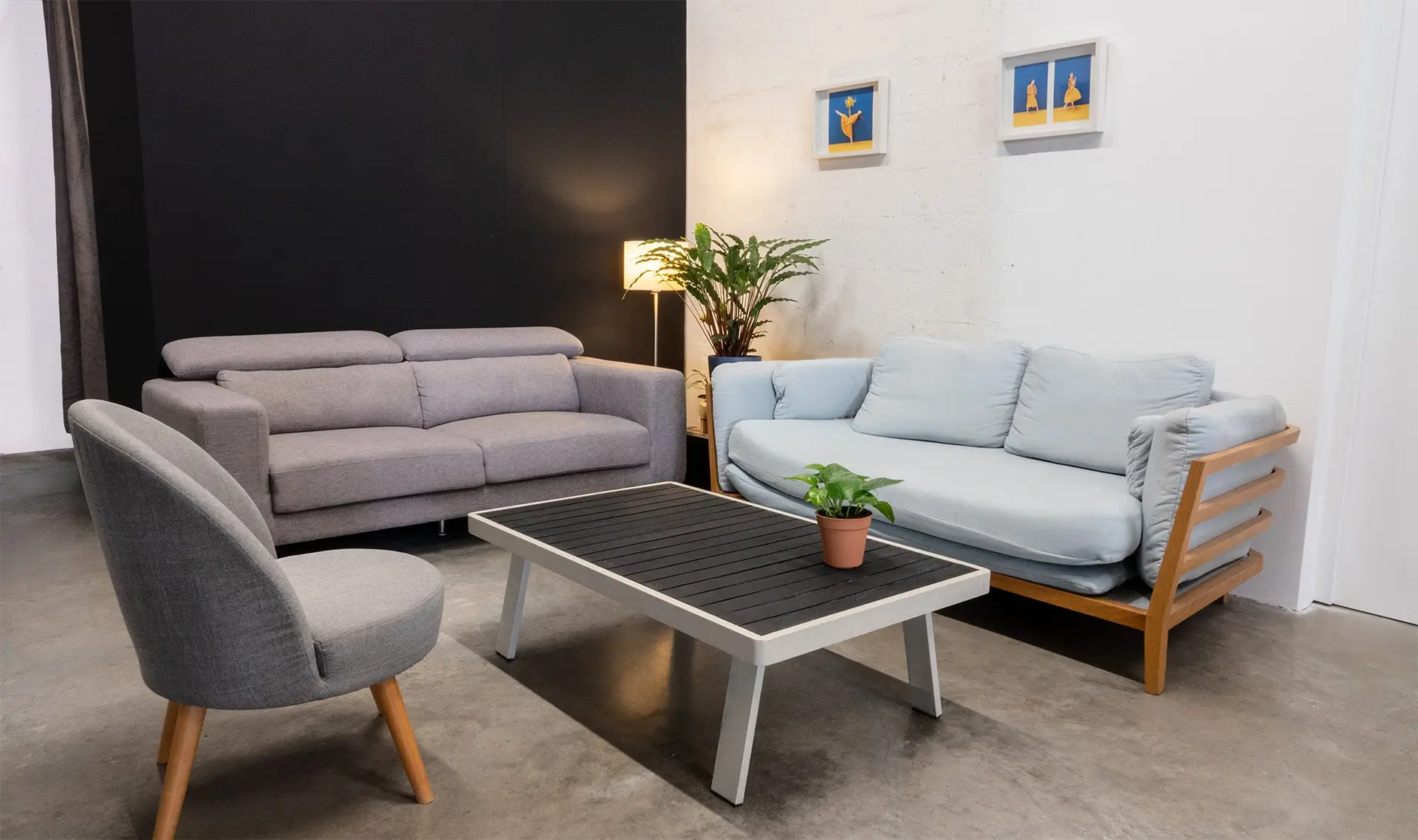 Client lounge with sofas and coffee table overlooking Set A filming studio