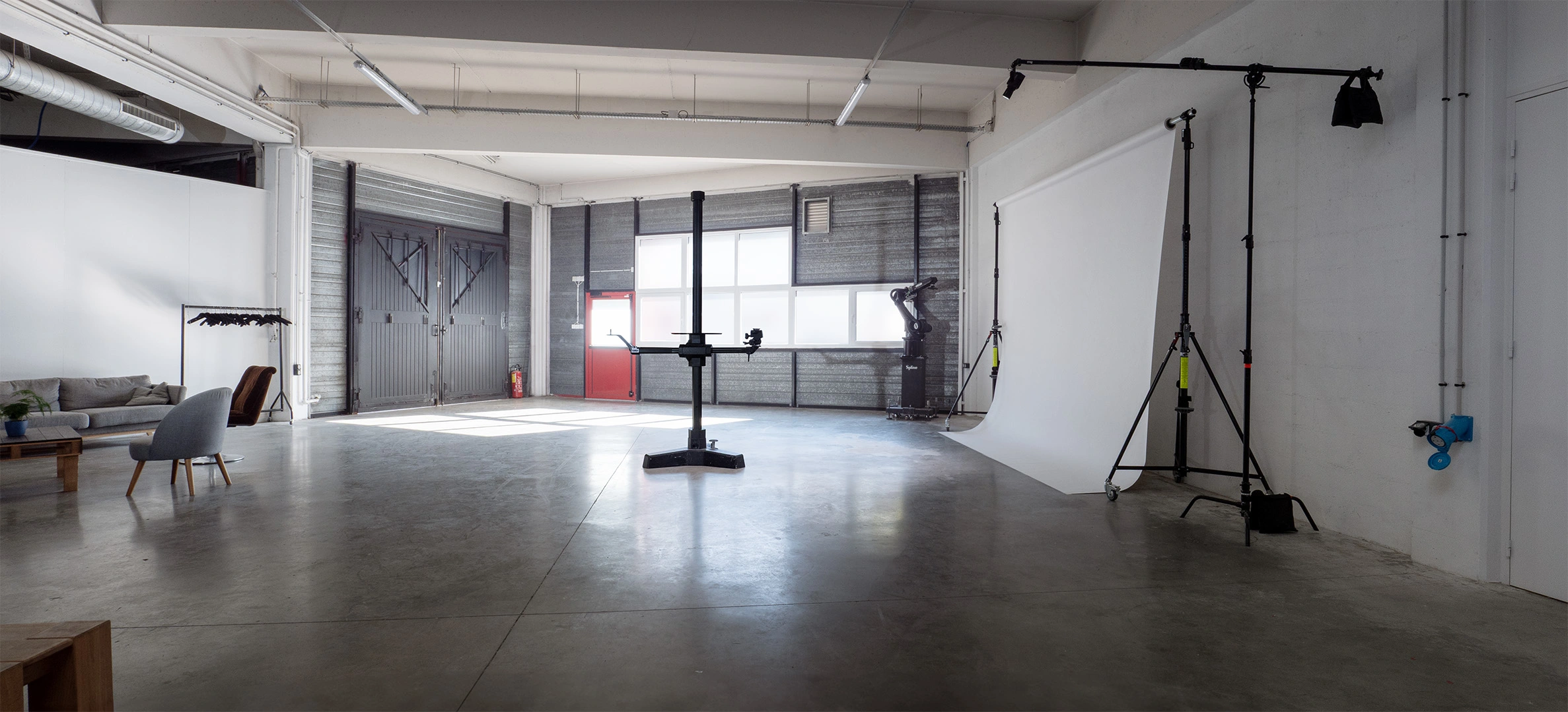 150sqm Set B filming studio with white industrial wall, colorama and lighting stands