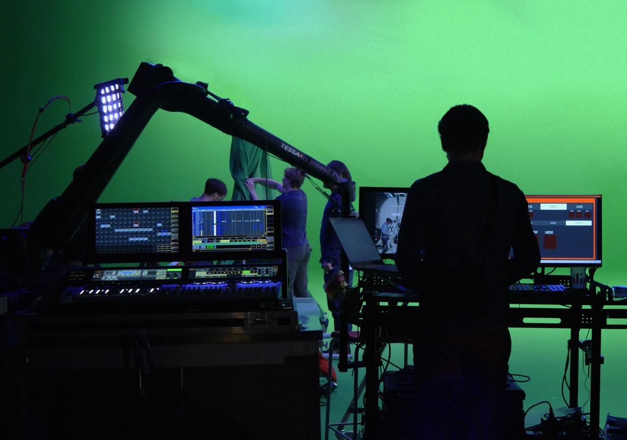 Two Spline motion control robotic arms set up in a white cyclorama studio