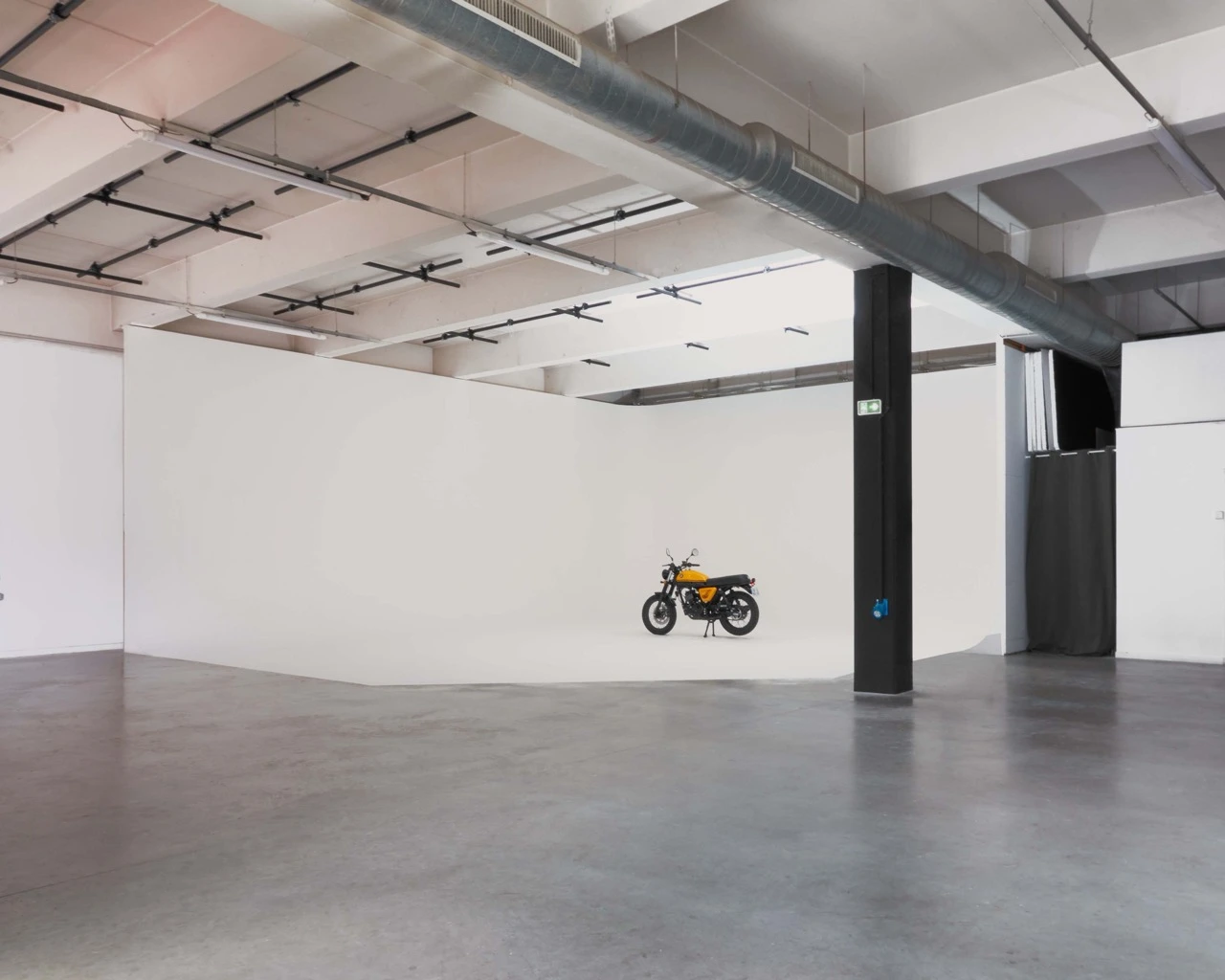 Empty white cyclorama filming studio with a motorcycle, Spline studios near Porte de la Villette
