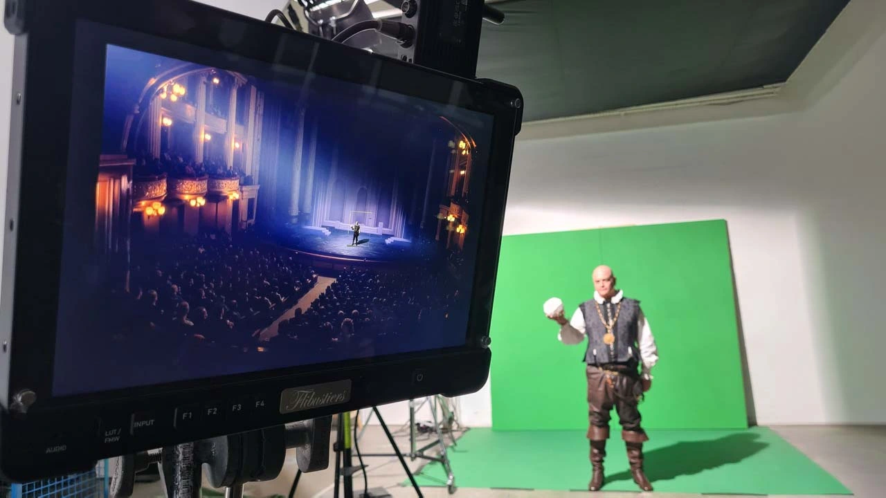 Camera operator filming a helicopter on location with a real-time VFX tracking wireframe overlay