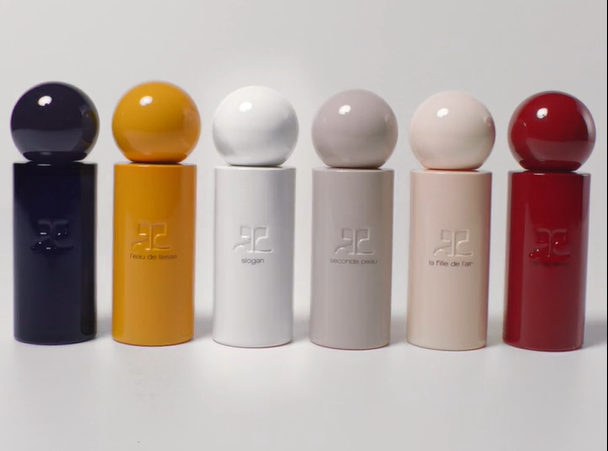 Six Courrèges fragrance bottles lined up in different colours for the Christmas campaign