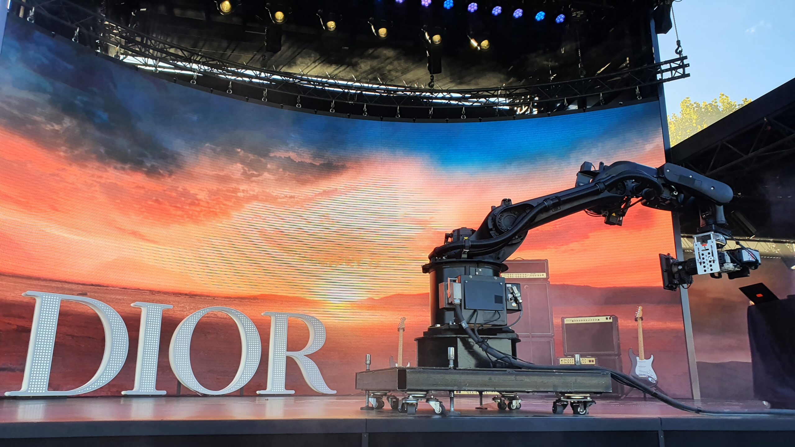 Glambot robotic arm in front of a sunset LED wall at the Dior activation, Rock en Seine 2022