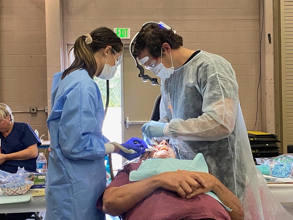 Dr Scott R Hill performing a dental procedure with a clinical assistant using advanced technology and precision care