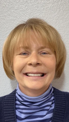 Woman smiling with a balanced natural looking smile after restorative dental care