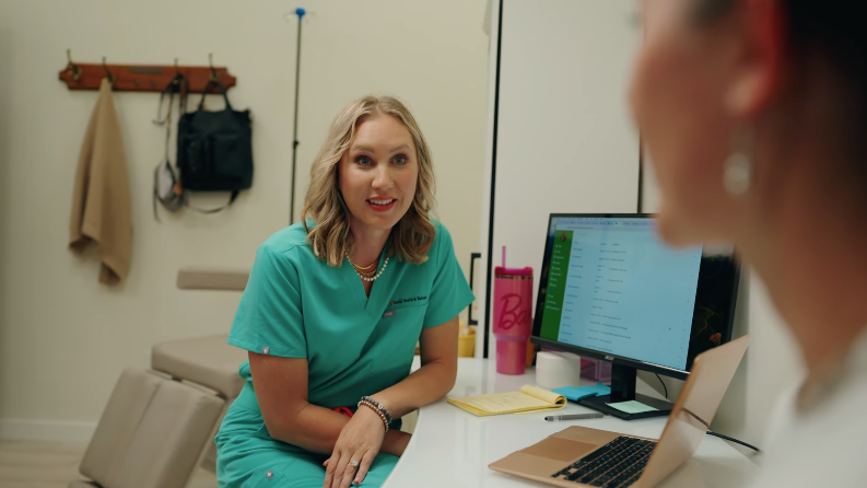 Corner Health provider smiling while talking with a patient