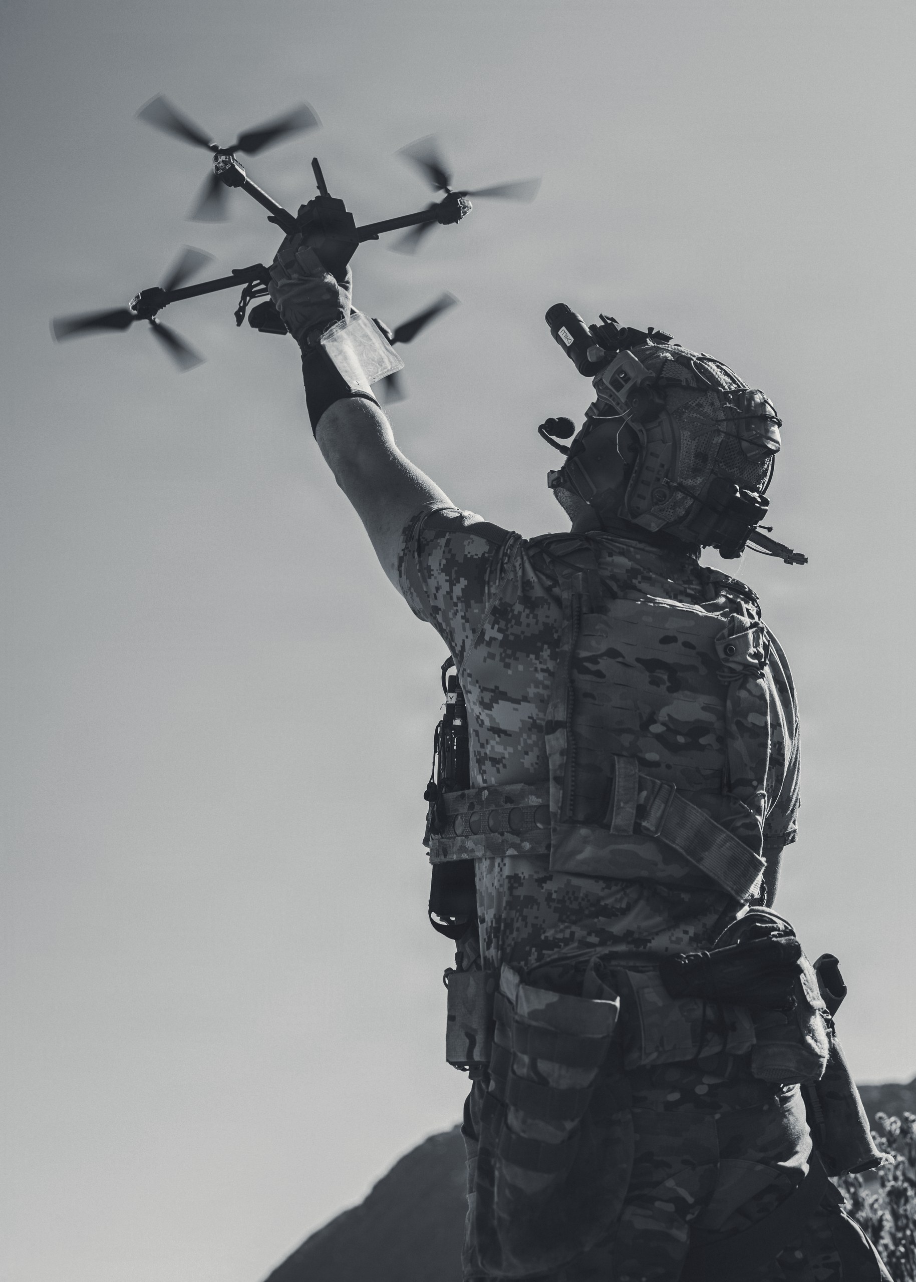 A warfighter launching a reconnaissance drone