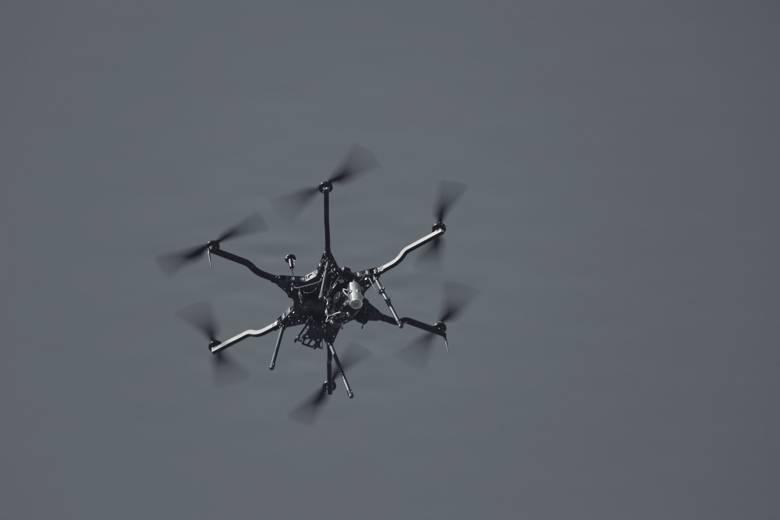 Hexacopter drone in flight against an open sky