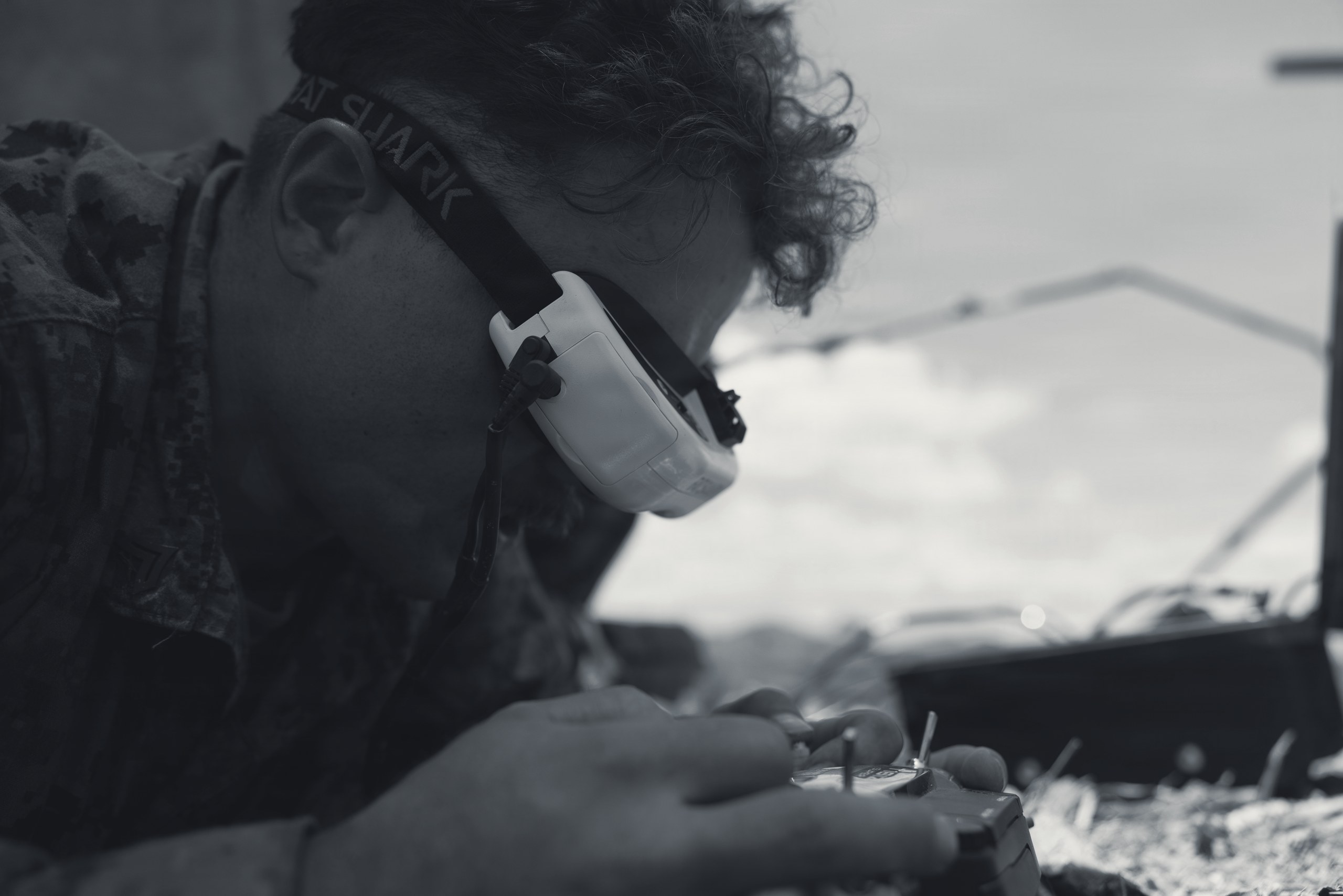 Drone pilot operating an FPV drone with goggles and controller