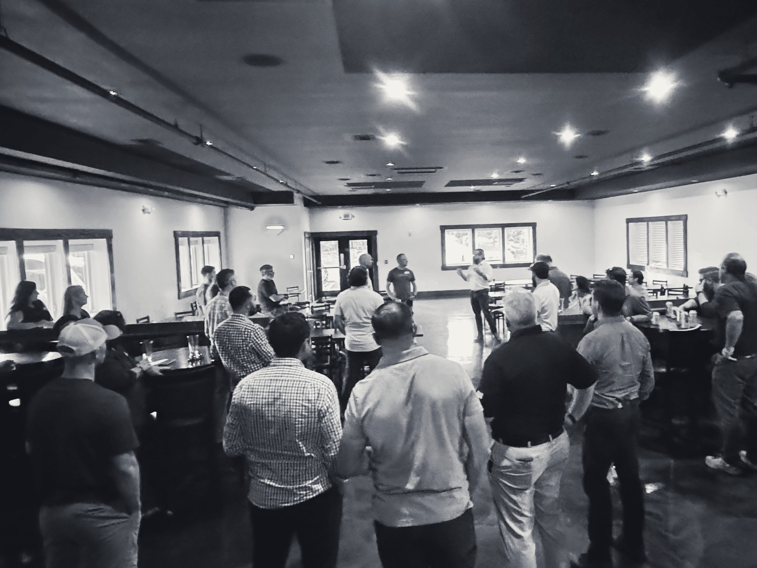 A full room of founders, veterans, and partners at a Watchtower gathering