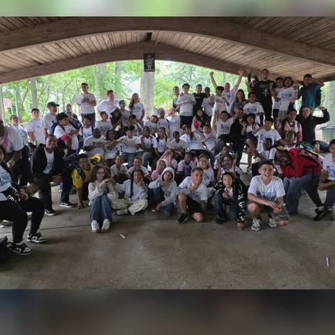 Large group of students posing together at an outdoor park pavilion