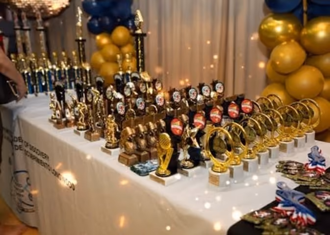 Awards table displaying trophies and medals at school ceremony